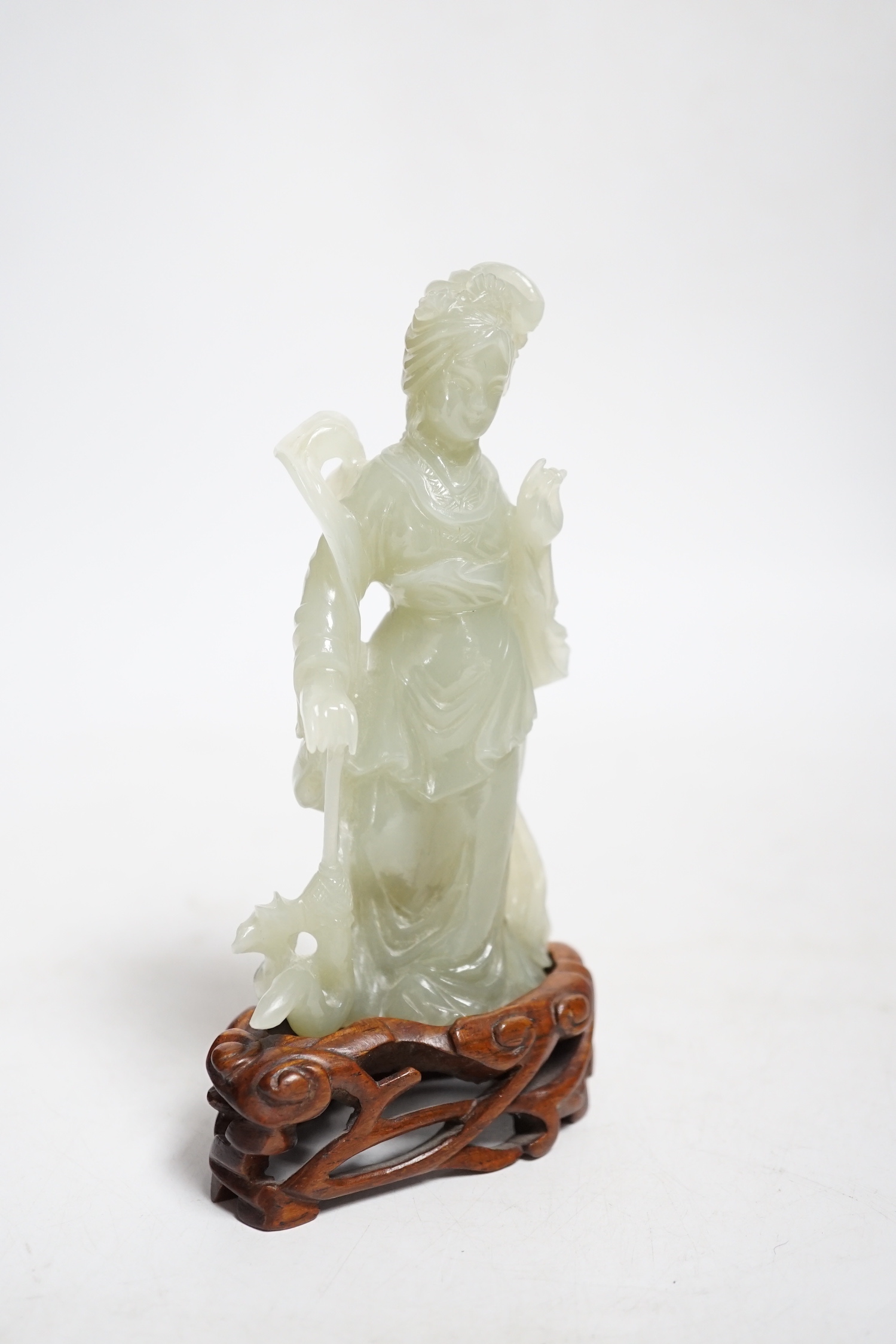 A Chinese celadon jade figure of a lady, on wood stand, 13cms high.